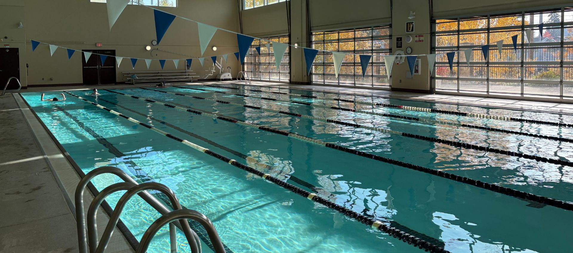 Indoor swimming pool at Hawthorn Farm Athletic Club in Hillsboro, Oregon, with bright natural light and members enjoying aquatic fitness—Make a Splash slider image.