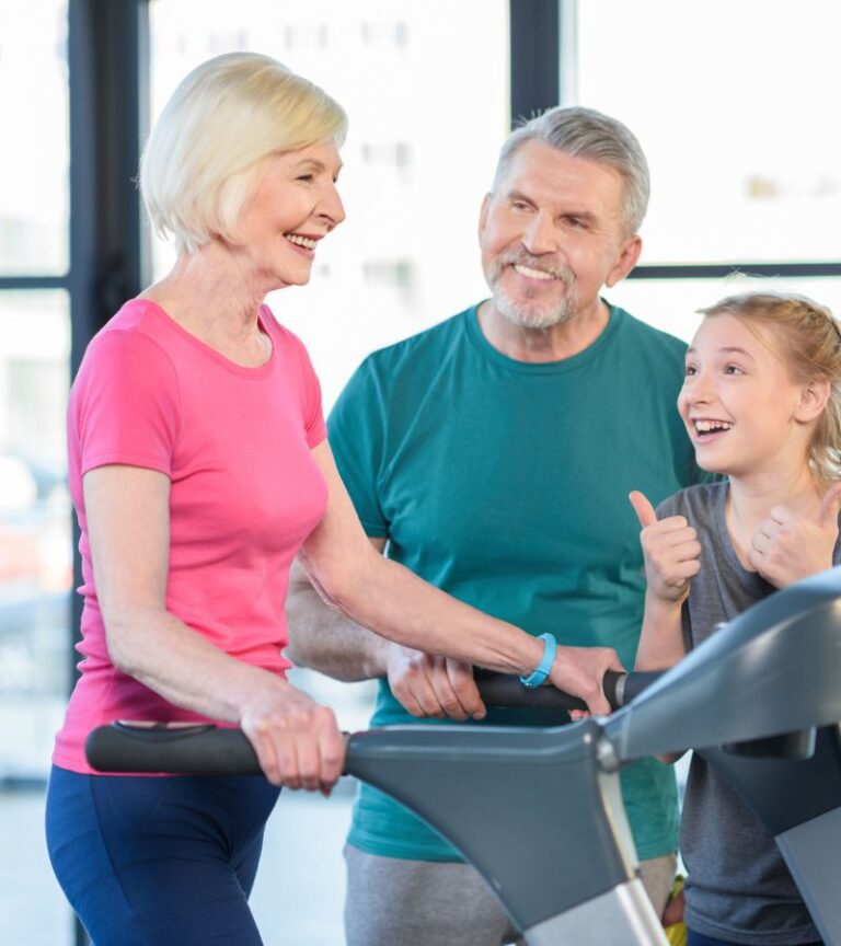 Senior adults and a child smiling together during a youth and senior fitness program at Hawthorn Farm Athletic Club in Hillsboro, promoting active lifestyles for all ages.